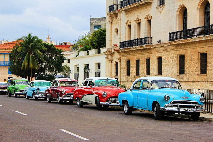 Classic cars lining a street of colonial buildings in Havana